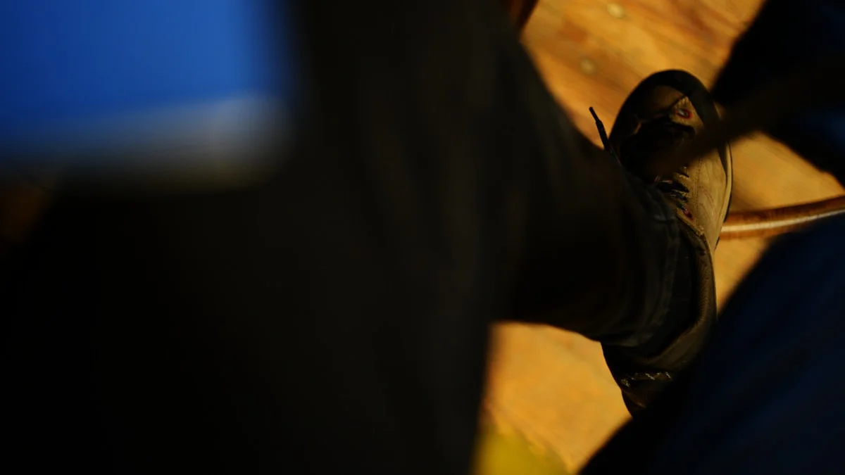 close-up of a person gently pressing the center of their heel, soft warm indoor lighting, peaceful atmosphere